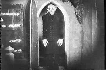 Max Schreck as Count Orlock passes through a doorway